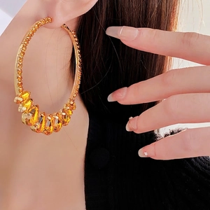 Exaggerated gold hoop earrings with amber crystals and yellow diamonds for women