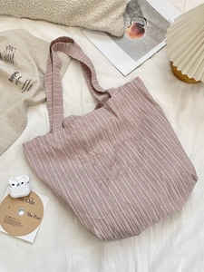 Pink striped canvas tote bag with 'You are so special' embroidery in a cozy home setting