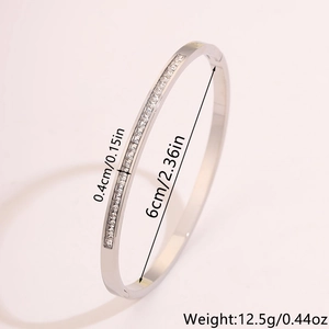 Detail view of silver stainless steel cz bangle with dimensions 6cm diameter and 0.4cm width