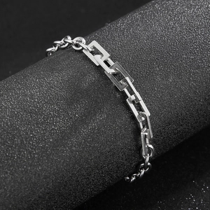 Macro shot of silver stainless steel geometric rectangular link bracelet on a black display