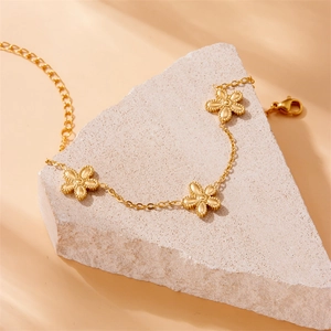 Elegant gold-plated stainless steel chain bracelet featuring three beaded five-petal flower charms