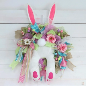 Detail of Easter bunny wreath with plush ears, colorful mesh ribbons and spring flowers