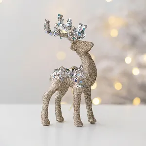 Close-up of a 15cm gold Christmas reindeer ornament with glitter and silver sequins