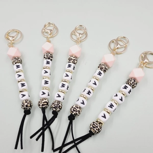 Detail of MAMA letter silicone bead keychain with leopard print beads and black tassel