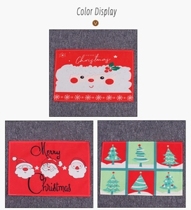 Detailed view of festive Christmas placemats with Santa Claus and Xmas tree patterns