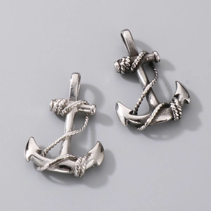 Detailed view of silver nautical anchor pendants with vintage engraved rope textures
