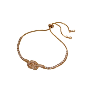 Gold plated knotted hollow bracelet for women featuring micro-set cubic zirconia accents