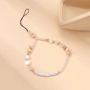 Detail of beaded phone wrist strap featuring white shell beads and golden accents
