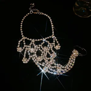 Sparkling rhinestone body chain harness featuring multi-layer silver tassels on black background