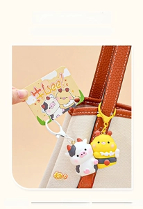 Close-up of cute cow and bee resin charms with magnetic feature on a stylish canvas bag