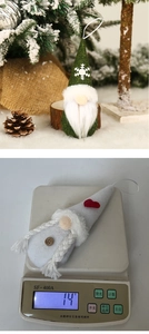 Detail view of gnome plush ornaments on a tree and their 14g weight measurement