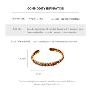 Detail view of 18k gold plated enamel flower bangle with copper and rhinestone materials