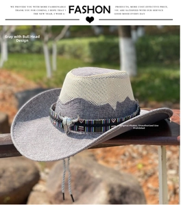 Detail of grey western cowboy straw hat with ethnic band and silver bull head ornament