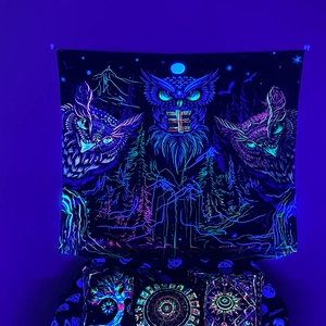 Macro shot of fluorescent owl tapestry glowing blue and purple under ultraviolet light