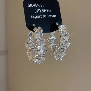 Irregular 925 sterling silver hoop earrings with channel-set baguette cubic zirconia
