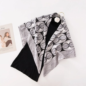 Silk feel scarf with geometric circle pattern styled over a black slim knit top