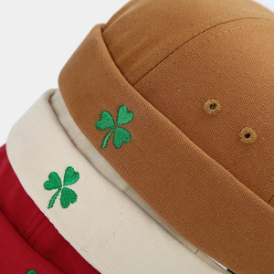 Fashionable docker hats with clover embroidery in brown, beige, and red canvas fabric