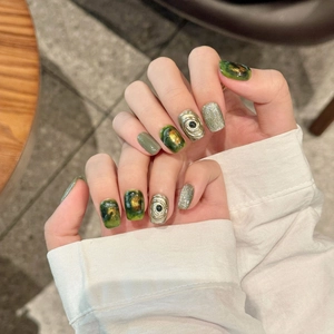Handmade emerald marble press-on nails with silver glitter and 3D metallic scroll relief