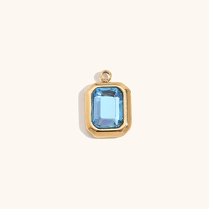 Detail of 14K gold plated octagonal pendant with faceted light blue gemstone centerpiece