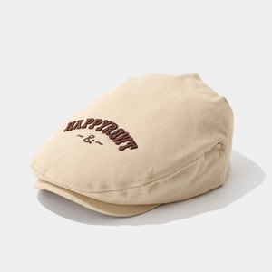 Détail du béret en coton beige avec broderie HAPPYROWT marron foncé en relief