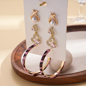 Detailed view of 6-piece earring set featuring pearls, hearts, and leopard print hoops