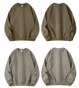 Detail view of olive green and light grey crewneck sweatshirts with ribbed cuffs and hem