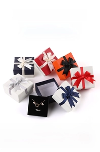 Detailed top view of elegant textured jewelry gift boxes with satin bow ribbon decorations