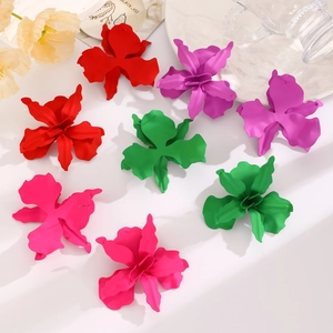Detail of oversized matte geometric floral earrings in red, purple, green, and rose colors