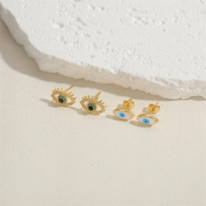 Gold-plated Evil Eye stud earring set with zircons and blue enamel on white stone