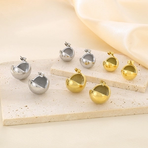 Macro shot of gold and silver hemispherical earrings in various sizes on stone stands