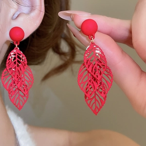 Detailed view of red hollow leaf earrings showing delicate petal textures and tassels