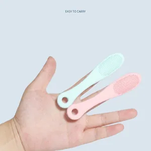 Silicone pet toothbrush and massage brush set in mint green and pale pink colors