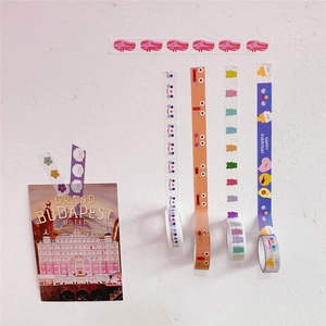 Detail showing six colorful cartoon washi tape rolls featuring pigs and smiley faces