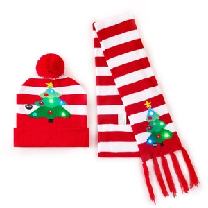 Detail of red and white striped knit Christmas hat and scarf set with glowing LED lights