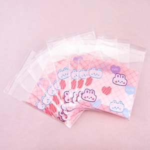 Close-up of cute rabbit patterned pink card inserts in clear self-sealing plastic bags