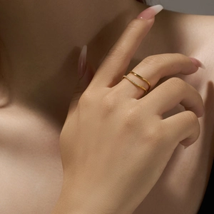 Detailed close-up of a double-layered gold ring with pave cubic zirconia on a model