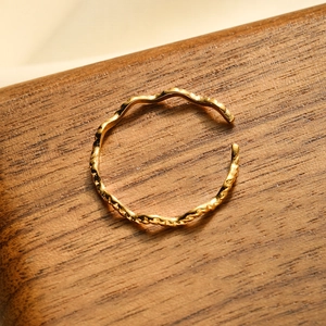 Minimalist 18K gold plated stainless steel open ring with wave texture on wood surface
