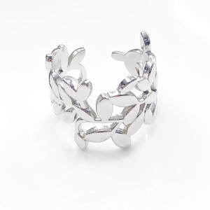 Detailed shot of silver adjustable open ring with hollowed-out leaf pattern design
