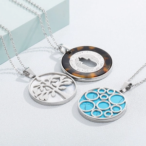 Three stainless steel tree of life necklaces with turquoise and tortoise shell pendants