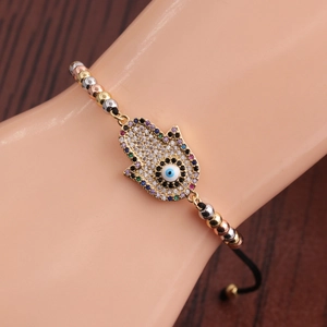 Bracelet Main de Fatma dorée avec œil maléfique et zircons sur cordon réglable
