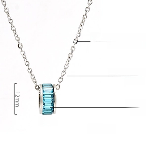Detailed view of cylindrical pendant with turquoise crystals and stainless steel chain