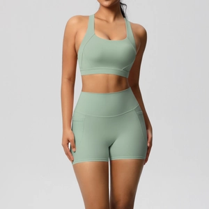 Detail of high-waisted mint green yoga shorts with side pocket for professional fitness