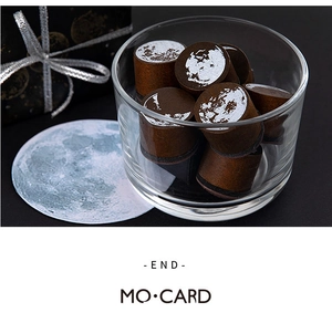 Detailed view of Moon Phase stamps featuring silver patterns in glass container