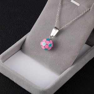 Detail of pink and teal enamel soccer pendant necklace on a premium jewelry display stand