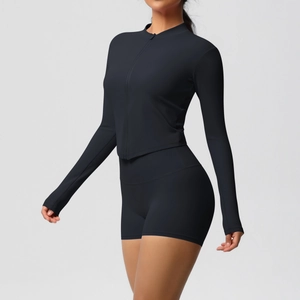 Detail of black two-piece yoga set with full-zip long sleeve top and high waist shorts