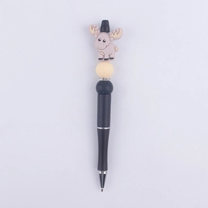Close-up of a cartoon reindeer bead on a black pen with sparkling rhinestone rings
