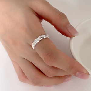 Close-up of 925 sterling silver adjustable ring with irregular texture on finger