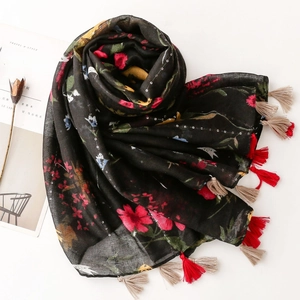 Floral cotton linen scarf with sequins, ethnic patterns and long tassels on black fabric