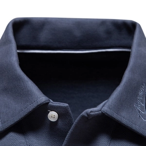 Men's navy blue cotton polo shirt with white button and cursive embroidery detail