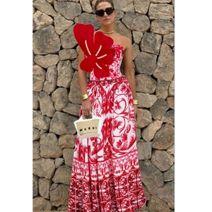 Detail of red floral dress with 3D butterfly bodice and elegant pearl embellishments